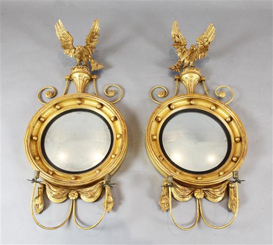 A pair of Regency style giltwood convex girandoles, W.1ft 8in. H.3ft 5in.
